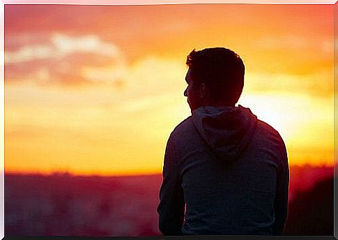 Man looks out over sunset