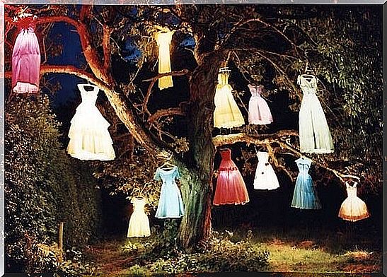 Colorful dresses hang in a tree