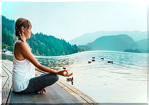 Woman meditating by the sea