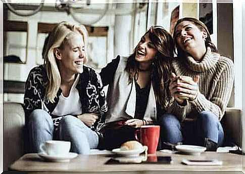 Girlfriends laughing on sofa