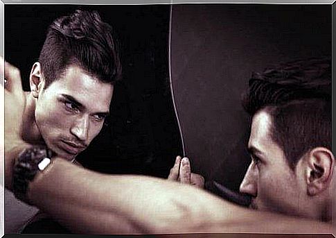 Narcissistic man looks at himself in mirror