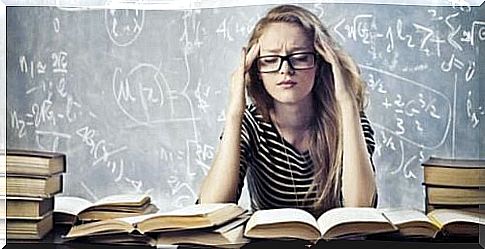 Woman sits in front of many books and takes care of herself