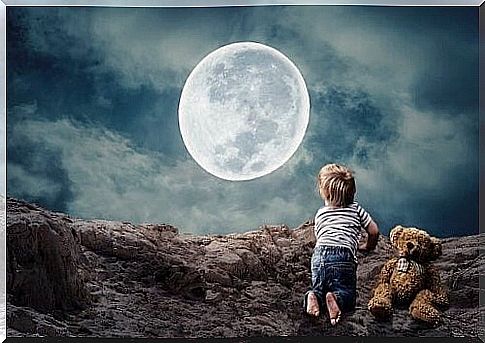 boy looks up at the moon