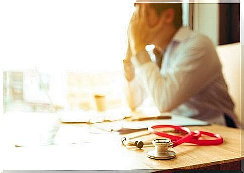 Tired male doctor symbolizes burnout in employees