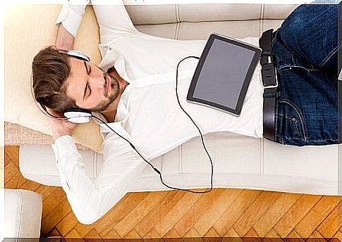 A man enjoying some music on the couch