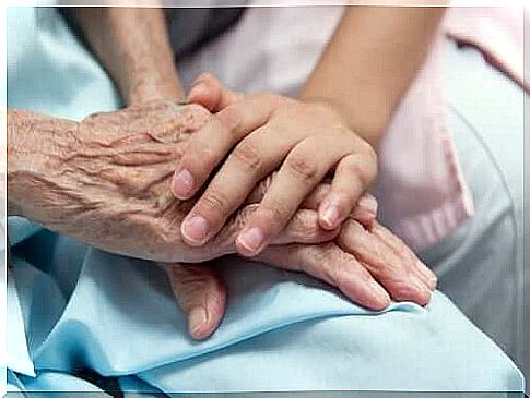 Child holds the hand of an elderly person