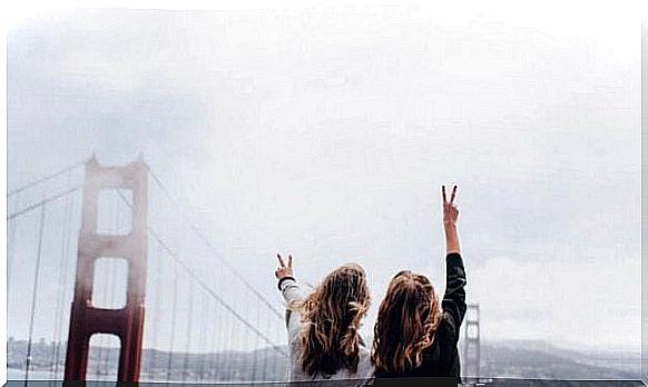 Two girls on bridge enjoy the benefits of a good travel companion