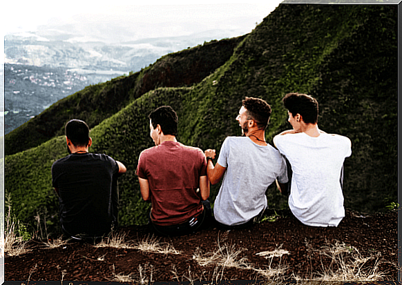 Four friends on mountain enjoy the benefits of a good travel companion