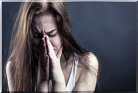 Crying woman with hands for nose