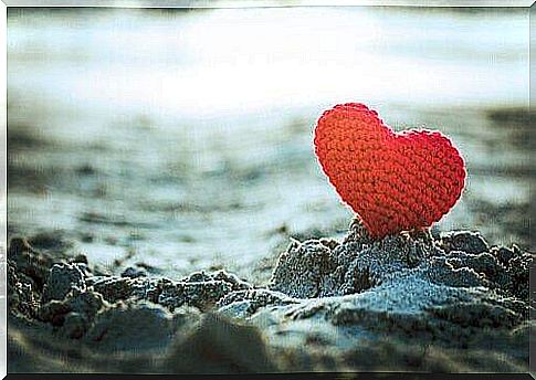 Crocheted heart in sand