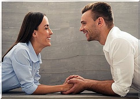 couple looking each other in the eyes and holding hands