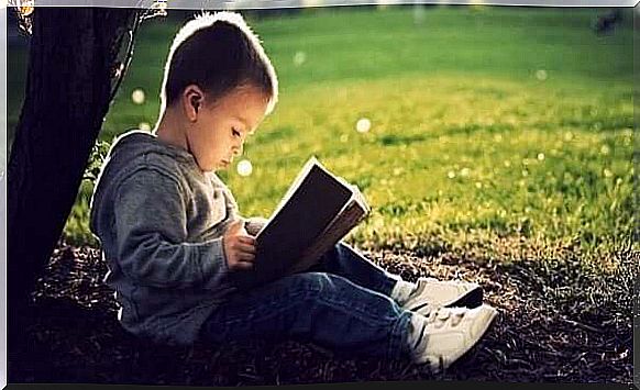 Little boy reading in a book