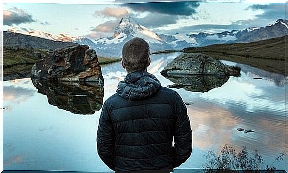 Man standing and enjoying lake view