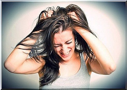 Woman tears herself in hair due to aggression over negative people