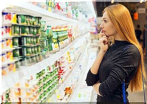 Woman looking at items in refrigerated counter