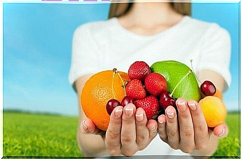 Women have their hands full of fruits, which are superfoods