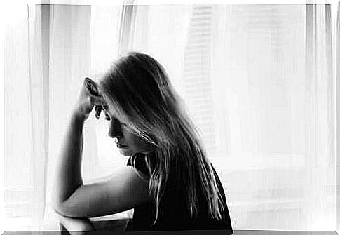 Woman in front of window with curtain drawn