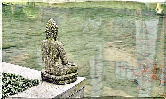 Buddha statue by water