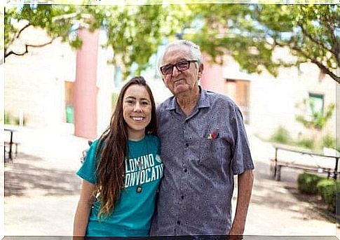 Elderly man with young girl in front of university