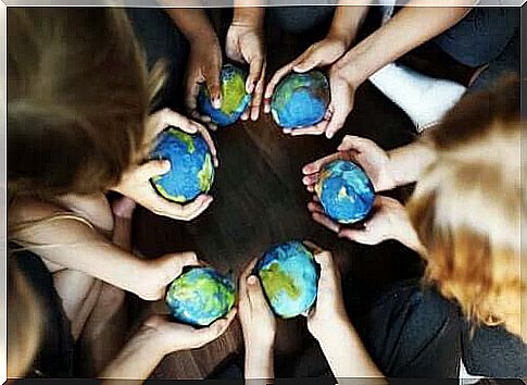 Children with small globes in hand