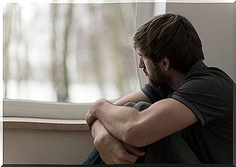 sad man looking out window