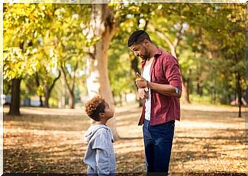 Dad talks to boy in forest