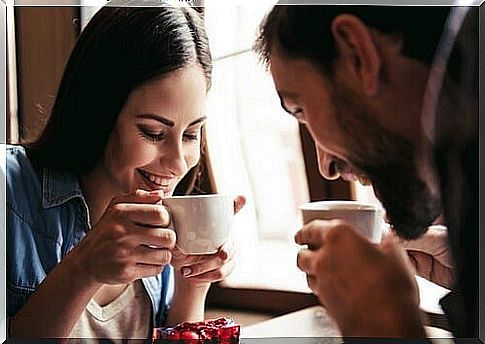 A couple drinking a cup of coffee together