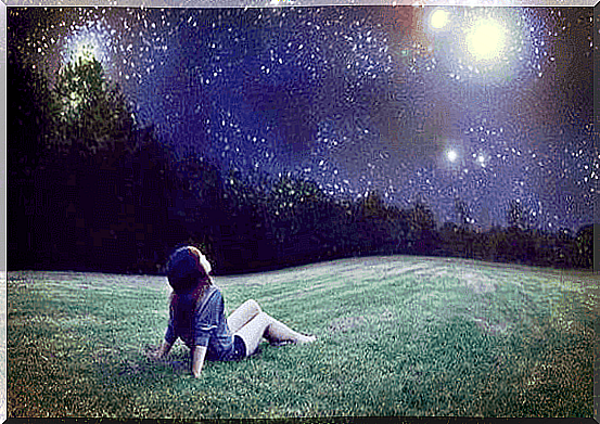 Girl enjoying beautiful starry sky