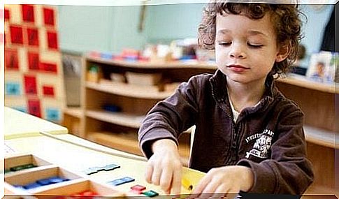 Boy playing under the influence of the Montessori method at a school