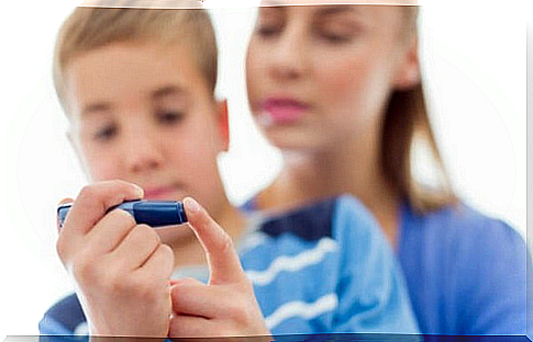 Boy with diabetes measures his blood sugar