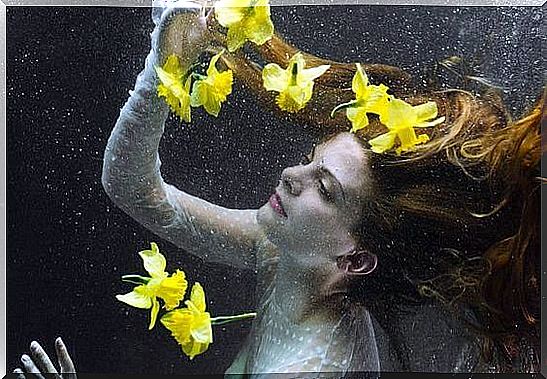 Woman in water with yellow flowers