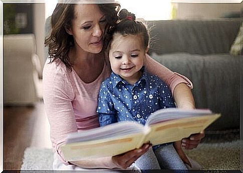 Mother is reading aloud to daughter