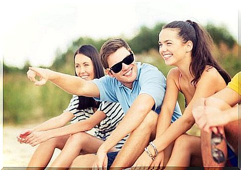 Friends laughing together on the beach