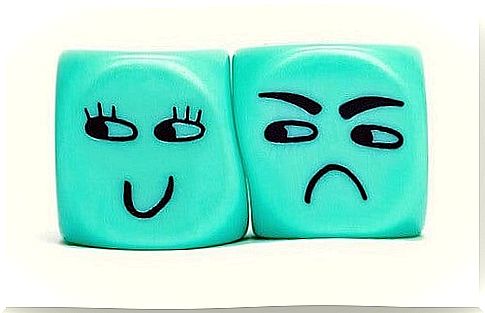 Blue angry cube illustrates being envious of the joy of smiling dice