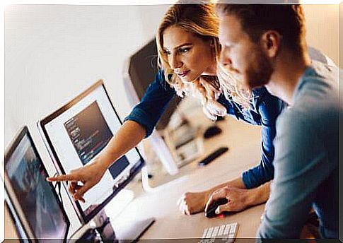 Man and woman looking at computer together