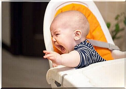 a child screams in high chair